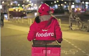  ?? KRISZTIAN BOCSI/BLOOMBERG ?? Foodora delivery couriers will be bringing customers junk food and everyday essentials such as milk and bread.