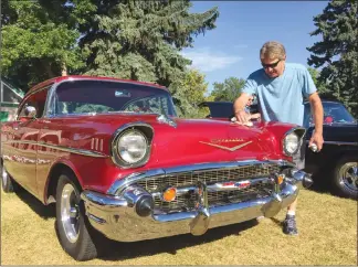  ?? Herald photo by Al Beeber ?? Dan Schneider of Medicine Hat keeps his 57 Chevy Bel Air pristine for the annual show and shine event at Galt Gardens as part of Street Machine weekend in Lethbridge on Sunday.