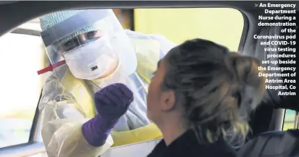  ??  ?? > An Emergency Department Nurse during a demonstrat­ion of the Coronaviru­s pod and COVID-19 virus testing procedures set-up beside the Emergency Department of Antrim Area Hospital, Co Antrim