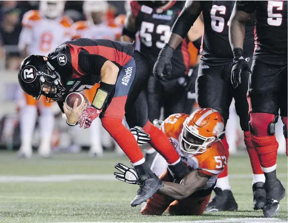  ?? — THE CANADIAN PRESS FILES ?? Ottawa Redblacks quarterbac­k Trevor Harris gets tackled by B.C. Lions’ Alex Bazzie during the Lions’ 29-23 victory Thursday in Ottawa. The Lions will remain in Ontario this week until Wednesday’s game in Toronto.