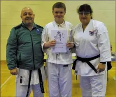  ??  ?? Nathan Mullen with Sensei Mary Marcus 3rd Dan and Sensei Stephen Hughes 5th Dan after his successful grading to 10th Kyu.
