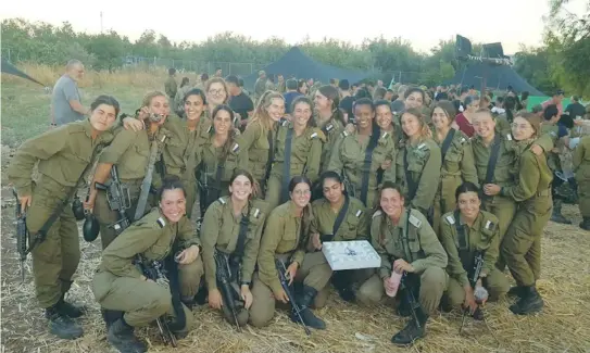  ?? (IDF) ?? THE WRITER and her comrades serve as a team and celebrate as a team.