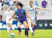  ?? ROY MILLER/ISI PHOTOS ?? The Pride’s Alex Morgan, left, battles the Thorns’ Emily Sonnett for the ball in a 2-0 loss on Sunday.