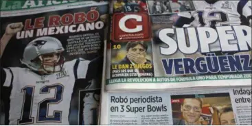  ?? ENRIC MARTI — THE ASSOCIATED PRESS ?? Front pages of Mexican newspapers show headlines and photos about the Tom Brady Superbowl jersey that was allegedly stolen by a Mexican journalist, bottom left on a selfie with Brady, in Mexico City, Mexico. The headlines read in Spanish “Super...