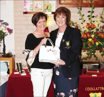 ??  ?? Mary Driver receiving her prize after Mary Kavanagh’s ladies captain’s prize at Coollattin Golf Club.