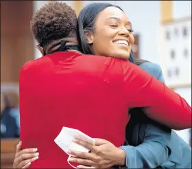  ??  ?? Jordan Wilson, daughter of former Mayor Karen Freeman-Wilson, congratula­tes her mother during the ceremony.