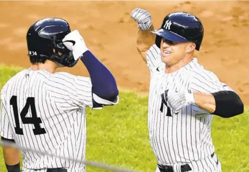  ?? AP ?? Brett Gardner (r.) celebrates his rare home run to left field with Tyler Wade on Monday night against the Phillies at Stadium.