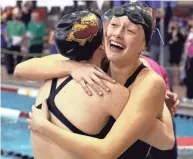  ?? SHANE FLANIGAN/THISWEEK ?? New Albany's Olivia Hovorka, facing, hugs teammate Carly Meeting after winning the state 400-yard freestyle relay.