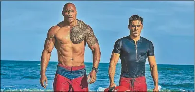  ?? UNIVERSAL ?? LOS BAÑEROS. Dwayne Johnson y Zac Efron, dos atletas del cine con pectorales y autoconsci­encia.