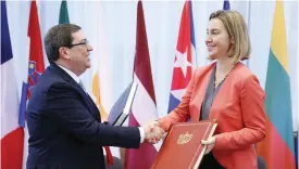  ??  ?? BRUSSELS: Cuba’s Foreign Minister Bruno Rodriguez Parrilla (left) shakes hand with EU foreign affairs and security policy chief, Federica Mogherini after signing an EU-Cuba Political Dialogue and Cooperatio­n Agreement in Brussels yesterday. — AFP