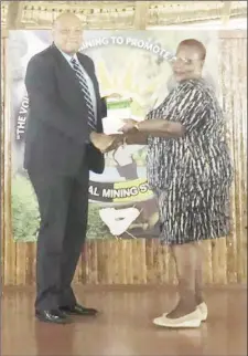  ??  ?? Minister of Natural Resources Raphael Trotman handing over the constituti­on to the President of the National Mining Syndicate, Cheryl Williams, yesterday.
