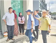  ??  ?? Azis (wearing cap) arriving at the MACC office yesterday morning.