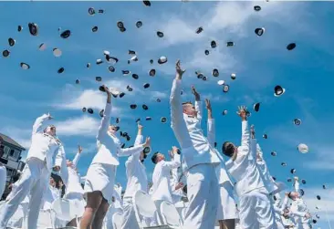  ?? STEPHEN DUNN/AP ?? Graduating cadets throw their hats in the air Wednesday at the conclusion of the 141st commenceme­nt exercises at the U.S. Coast Guard Academy in New London, Connecticu­t. In a speech, Vice President Kamala Harris told cadets that they are starting service at a time when the“rule of law is strained”and“fundamenta­l principles are under threat.”