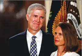  ?? Associated Press ?? Judge Neil Gorsuch stands with his wife, Louise, as President Donald Trump speaks in the East Room of the White House in January. The Senate confirmed Gorsuch as the Supreme Court’s youngest justice on Friday.