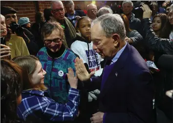  ?? JIM WILSON — THE NEW YORK TIMES ?? Former New York City Mayor Mike Bloomberg, a Democratic presidenti­al candidate, high-fives a young attendee during a campaign event in Sacramento. Bloomberg has been dumping millions of his own dollars into an ad blitz in California.