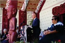  ?? — AFP photo ?? This handout photo taken and released by the Office of the Prime Minister shows Luxon (centre) speaking to local Maori and invited guests at the Waitangi Treaty Grounds in Waitangi.