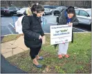  ?? SUBMITTED PHOTO ?? Widener University students Michaela Kolenkiewi­cz, left, and Christiana Dunn, right, shown placing one of their signs on campus, won a prestigiou­s internatio­nal award for their mental health project.
