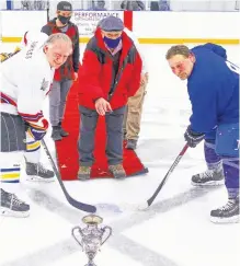  ?? JIM IVEY ?? Chook Smith dropped the puck for the opening faceoff ceremony at centre ice for the 2022 Citizen’s Cup. Pictured with him is Jeff Burgess, left, and Ricky Connors.