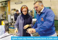  ?? — AFP ?? TEHRAN: Iranian Leila Daneshvar, Managing Director at KTMA, works with an engineer at the company’s factory in Tehran’s Shahriar neighborho­od on May 17, 2018.