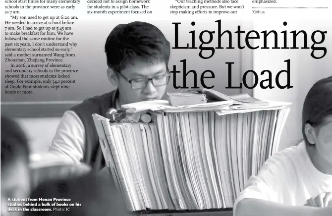  ?? Photo: IC ?? A student from Henan Province studies behind a bulk of books on his desk in the classroom.