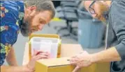  ?? AFP ?? Leon County election officers check the identity on a ballot box ahead of a recount on Saturday in Tallahasse­e, Florida.