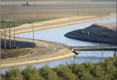  ?? PHOTO/RUSSEL A. DANIELS ?? In this Oct. 2, 2009 file photo, in California’s Westland Water District of the Central Valley, canals carry water to southern California. The Trump administra­tion says it will look at ramping up water deliveries to farmers from California’s massive...