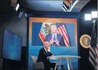  ?? SARAHBETH MANEY THE NEW YORK TIMES ?? President Joe Biden listens as California Gov. Gavin Newsom speaks during a virtual meeting with governors to discuss wildfire prevention, preparedne­ss and response efforts, at the White House in Washington in July.