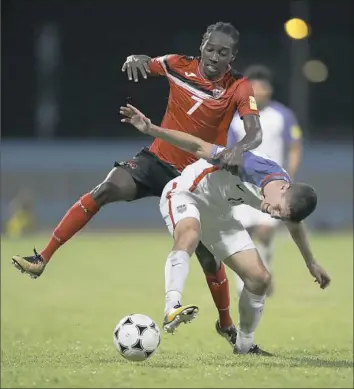  ?? Associated Press ?? Team USA’s Christian Pulisic, front, fights for control of the ball with Trinidad and Tobago's Nathan Lewis Tuesday night in Couva, Trinidad.