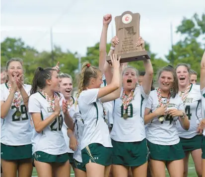  ?? STEVE RUARK/FOR BALTIMORE SUN MEDIA ?? Century’s Anna Hackett hoists the trophy as she and her teammates celebrate after a 16-6 win over Hereford in the Class 2A girls lacrosse state championsh­ip Wednesday at Loyola Maryland’s Ridley Athletic Complex.