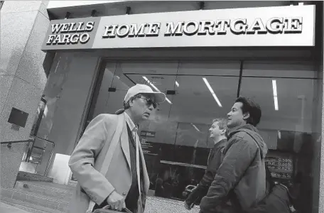  ?? Justin Sullivan Getty Images ?? IN LOS ANGELES’ case against Wells Fargo, it alleges that black mortgage borrowers were more than twice as likely as white borrowers with similar credit scores to receive loans the city deemed predatory. Latino borrowers were 1.5 times as likely.
