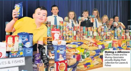  ??  ?? Making a difference Dillon Christie and his Murray classmates proudly display their collection for Loaves &amp; Fishes