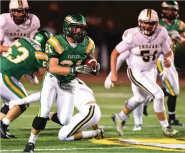  ?? STAFF PHOTO BY ROBIN RUDD ?? Rhea County’s Cody Bice (21) breaks into the open last October against Soddy-Daisy. The Eagles and the Trojans hope to be among the contenders in Region 4-5A this year.