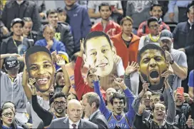  ?? REBECCA BLACKWELL / ASSOCIATED PRESS ?? NBA fans hold up cut-out images of their favorite players (from left: Russell Westbrook, Jeremy Lin and Paul George) during the Oklahoma City Thunder’s game against the Brooklyn Nets in Mexico City on Dec. 7.