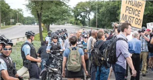  ?? ASHLEE REZIN/SUN-TIMES ?? Flanked by Chicago police officers, anti-violence protesters march in the southbound lanes of Lake Shore Drive near Belmont on Thursday.