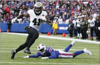  ?? JEFFREY T. BARNES — ASSOCIATED PRESS ?? Saints running back Alvin Kamara rushes past Bills’ Shareece Wright in the first half of Sunday’s game in Orchard Park, N.Y.