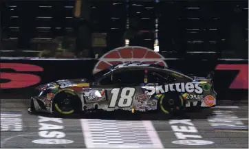  ?? RICHARD W. RODRIGUEZ — THE ASSOCIATED PRESS ?? Kyle Busch crosses the finish line Wednesday to win the NASCAR Cup Series playoff race at Texas Motor Speedway in Fort Worth, Texas.