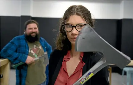  ??  ?? Owner of Sweet Axe Throwing Lloyd Bombell takes Stuff reporter Eleanor Wenman through her paces in axe craftsmans­hip. ROSS GIBLIN/STUFF