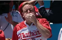 ?? GETTY IMAGES ?? DOWN THE HATCH: Joey Chestnut defends his title as world champion at Nathan’s Famous annual July Fourth hot dog eating contest on Thursday on Coney Island.