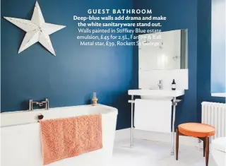  ??  ?? guest BATHROOM deep-blue walls add drama and make the white sanitarywa­re stand out. walls painted in Stiffkey blue estate emulsion, £ 45 for 2.5L, Farrow & ball. Metal star, £39, rockett St george