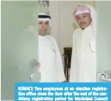  ?? — KUNA photo ?? KUWAIT: Two employees at an election registrati­on office close the door after the end of the candidacy registrati­on period for Municipal Council elections yesterday.