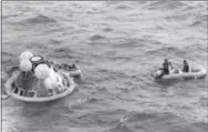  ?? THE ASSOCIATED PRESS ?? In this file photo, the Apollo 11 command module lands in the Pacific Ocean and the crew waits to be picked up by U.S. Navy personnel after an eight day mission to the moon. The Apollo 11 command module, which travelled more than 950,000 miles to take...