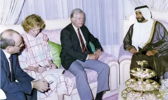  ??  ?? Sheikh Zayed with Jimmy Carter and his wife during the former US president’s visit to the Arabian Gulf in the 1990s, above; a Pakistani health worker administer­s polio vaccine drops, top AFP