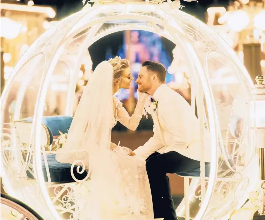  ?? ZACK WITTMAN/THE NEW YORK TIMES ?? Marissa Branch and Shelby Blackstock inside Cinderella’s coach after their wedding Feb. 12 at Walt Disney World.