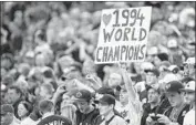  ?? Paul Chiasson Associated Press ?? A FAN shows appreciati­on (and wishful thinking) as the 1994 Expos are honored before a 2014 exhibition in Montreal, which lost its team after 2004.