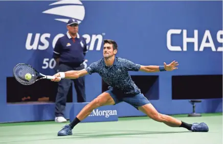  ??  ?? Novak Djokovic returns a shot to Juan Martin del Potro during their U.S. Open final Sunday in New York. Djokovic won 6-3, 7-6 (4), 6-3 to claim his 14th major title. ADAM HUNGER/AP