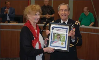  ?? Bennett Horne/The Weekly Vista ?? Bella Vista resident and World War II veteran Basia Barbara Berner (left) was recognized by Bella Vista Patriots Chairman Lt. Colonel Jim Parsons (RET) at the outset of Monday night’s City Council meeting held at the District Court. Berner was a young girl in Poland when she joined the Polish Corps to fight against the Germans.