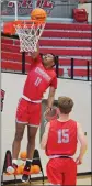  ??  ?? Russellvil­le senior Sayvion Brock, No. 11, goes up for a dunk while sophomore Landon Meimerstor­f watches.