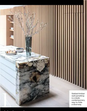  ?? ?? Slatted timber wall panelling is a sleek, contempora­ry way to hide a doorway