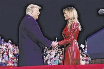  ?? Evan Vucci The Associated Press ?? President Donald Trump greets first lady Melania Trump after she introduced him Saturday at a campaign rally for Senate Republican candidates in Valdosta, Ga.