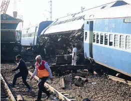  ?? — AFP ?? The derailed coaches of Vasco Da Gama- Patna Express near Manikpur railway station in Uttar Pradesh on Friday.